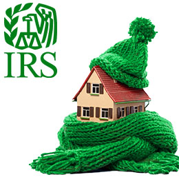 Small house wearing a green knit scarf and hat. Green IRS logo. 