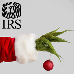 Hairy green hand wearing a red coat holding a holiday tree ornament. Black IRS logo. 